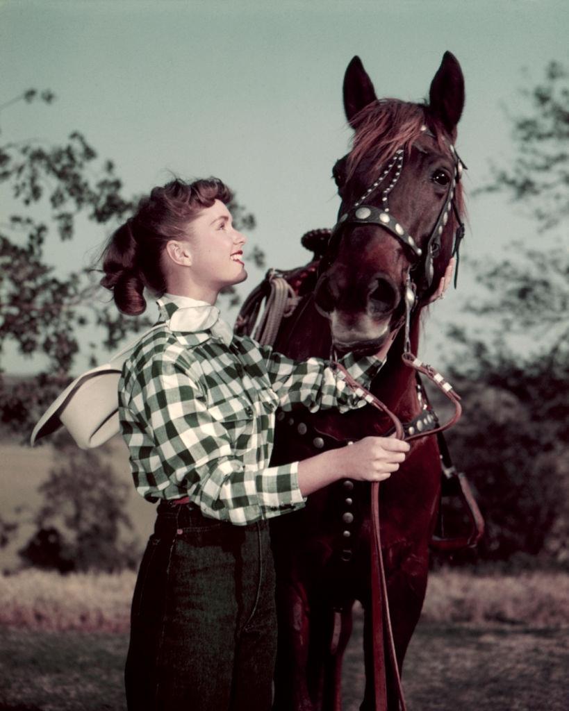 #65 Debbie Reynolds with a horse, 1955.