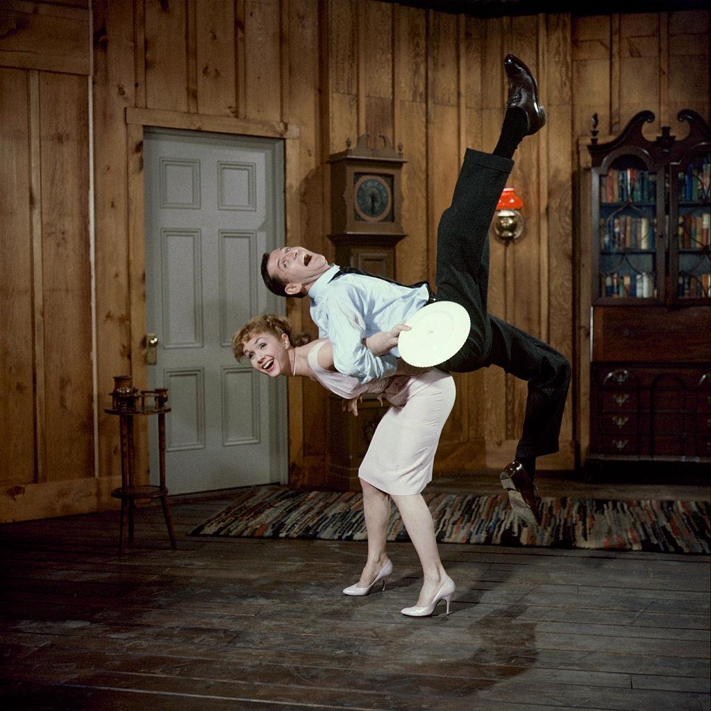 #75 Debbie Reynolds lifts fellow actor Tony Randell, 1959.