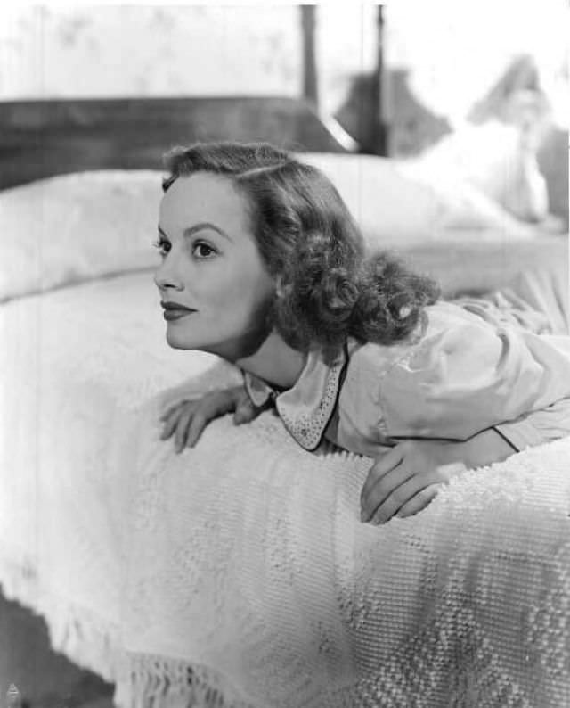 #46 Faye Emerson on her bed, 1955.