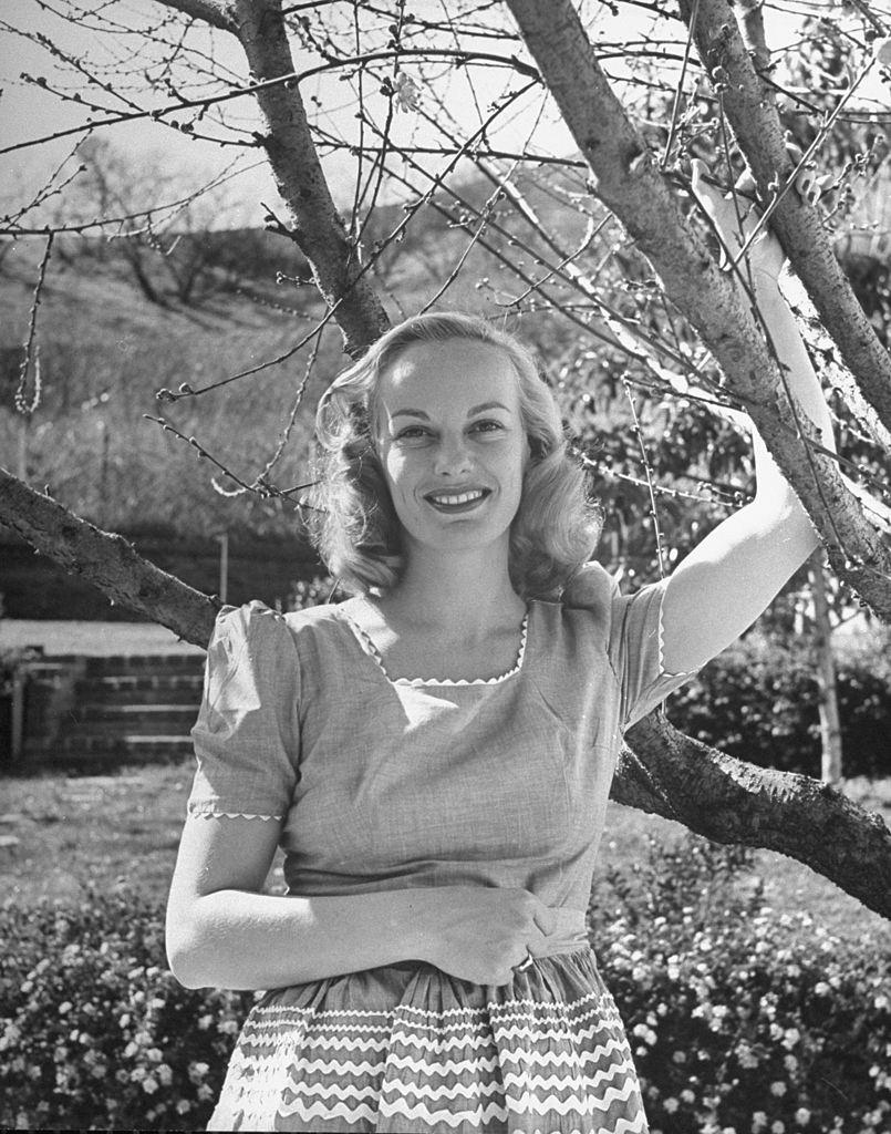 #5 Faye Emerson, standing in her yard, 1945.