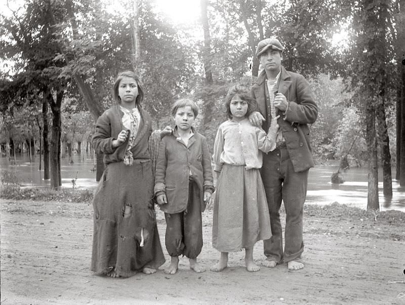 #23 Man and children in rags with bare feet, circa 1910