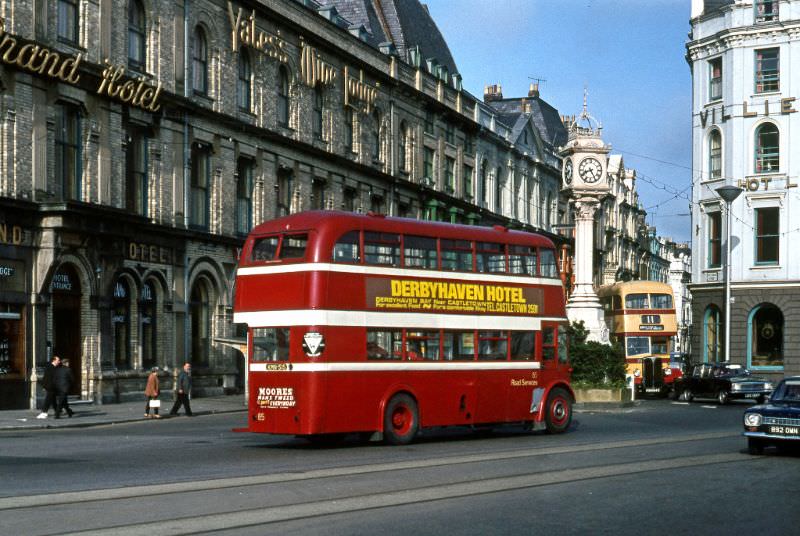 #25 Road Sers No.85, a 1950 built Leyland PD2 passes the Clock Tower on the prom at Douglas with Corpn Regent No.71 just appearing, 2 July 1971