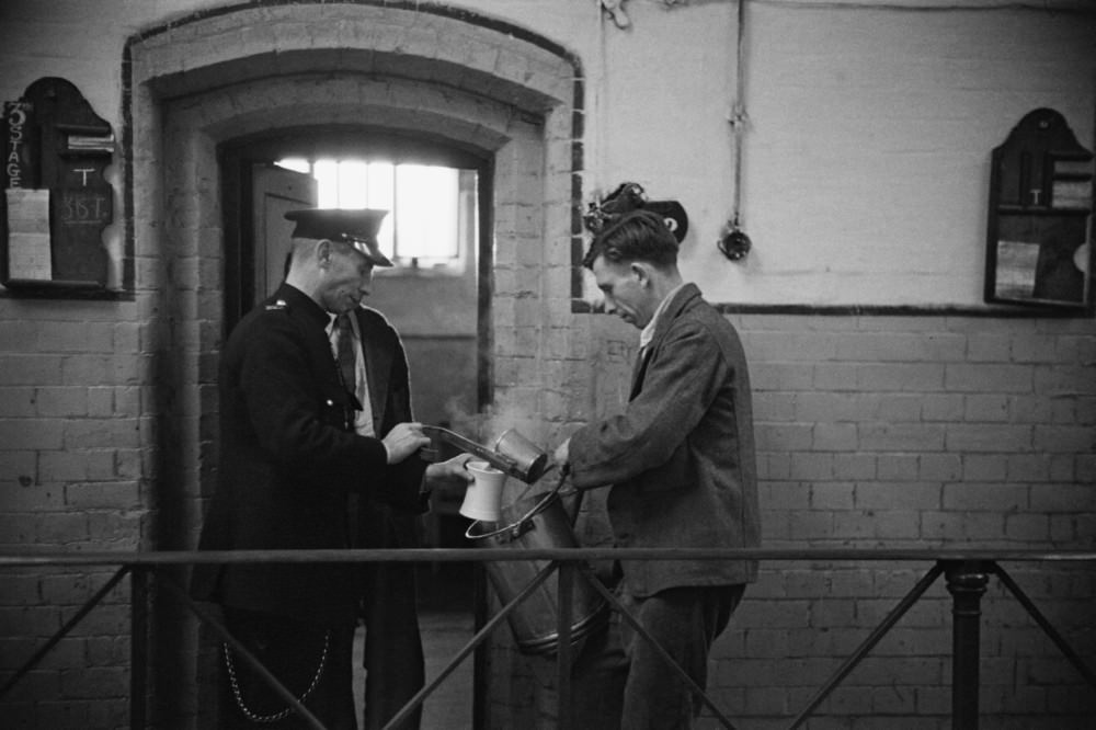 #12 Prison officer Davidson serving a prisoner a meal at Strangeways Prison.