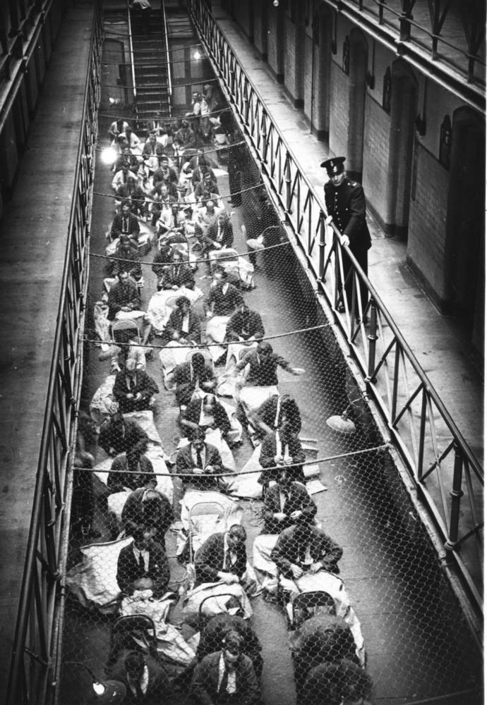 #6 A prison officer watches over prisoners who are busy sewing mailbags in Strangeways Prison.