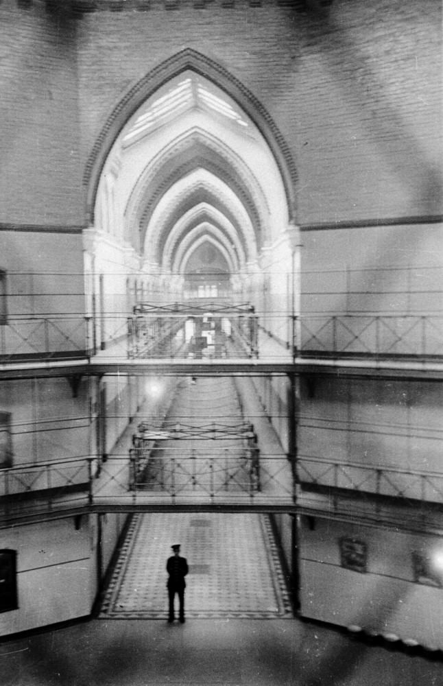 #9 A prison officer surveys his dominion at 6.30 in the morning shortly before the wake-up bell at Strangeways Prison.