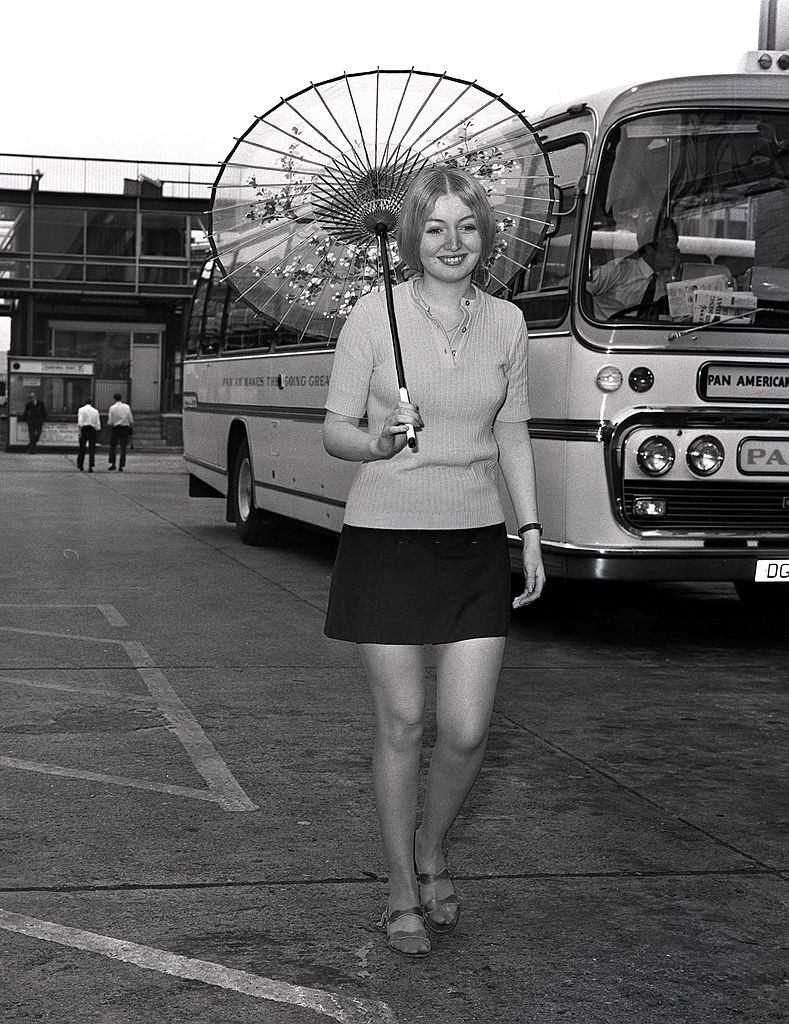 #52 Mary Hopkin holding an oriental parasol after arriving at Heathrow airport from Osaka, Japan where she sang on television, 1970.
