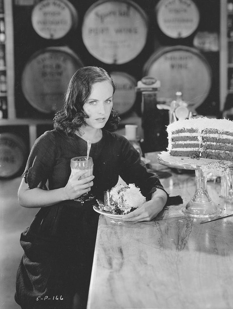 #34 Paulette Goddard holds a plate of cake and a milkshake, 1936.