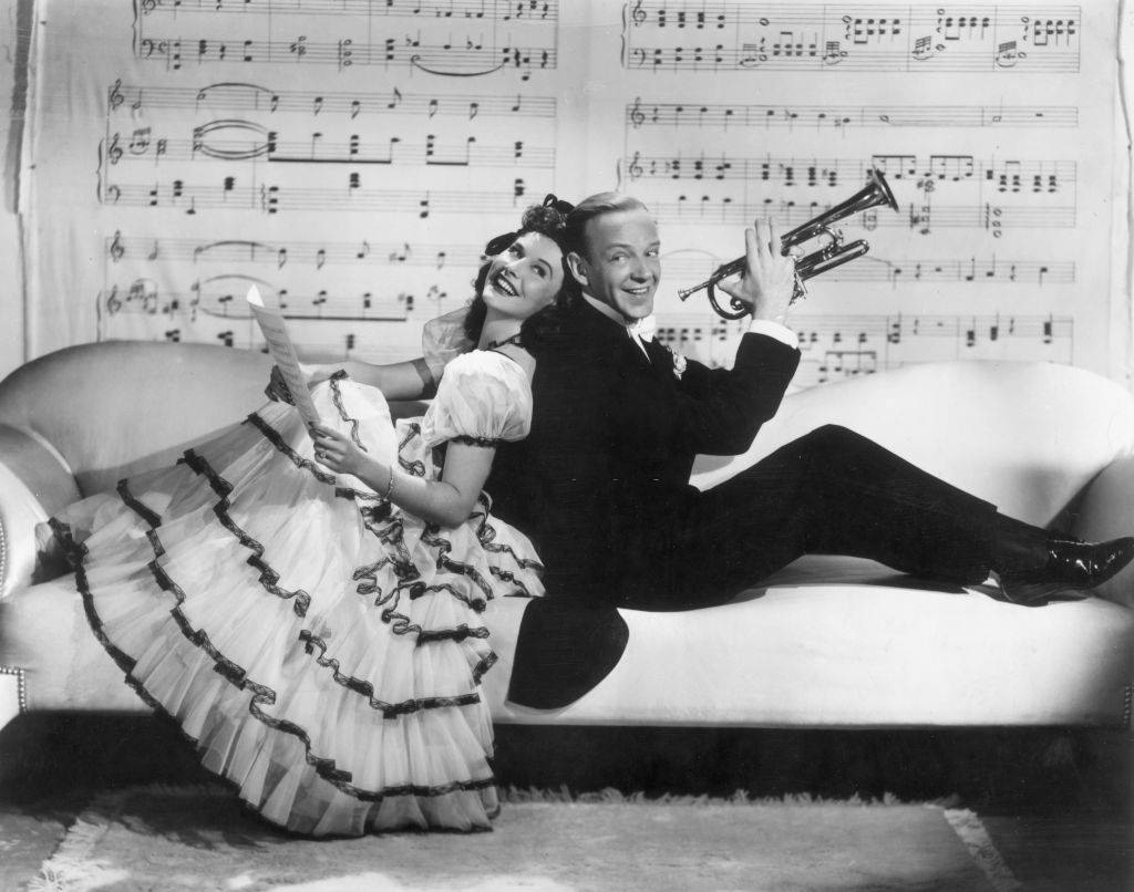 #47 Paulette Goddard with Fred Astaire sitting on the sofa, 1940.