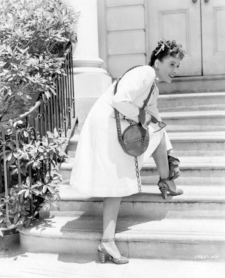 #72 Paulette Goddard adjusting the strap on her shoe in a scene from the movie, ‘Star Spangled Rhythm’, 1942.