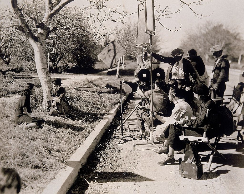 #28 Paulette Goddard with Charlie Chaplin on the set of ‘Modern Times’, 1936.