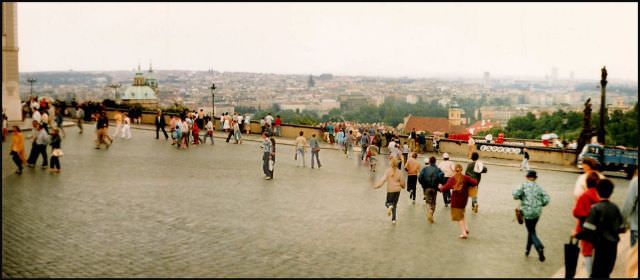#6 A coachload of students disgorges onto the plaza of Hradcány castle, with Prague city centre beyond