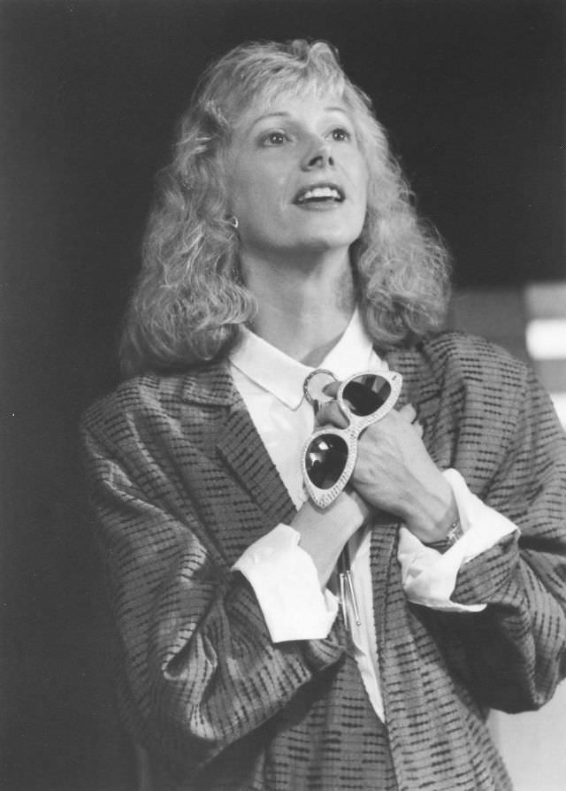 #50 Sondra Locke holding a fancy glasses, 1970s.