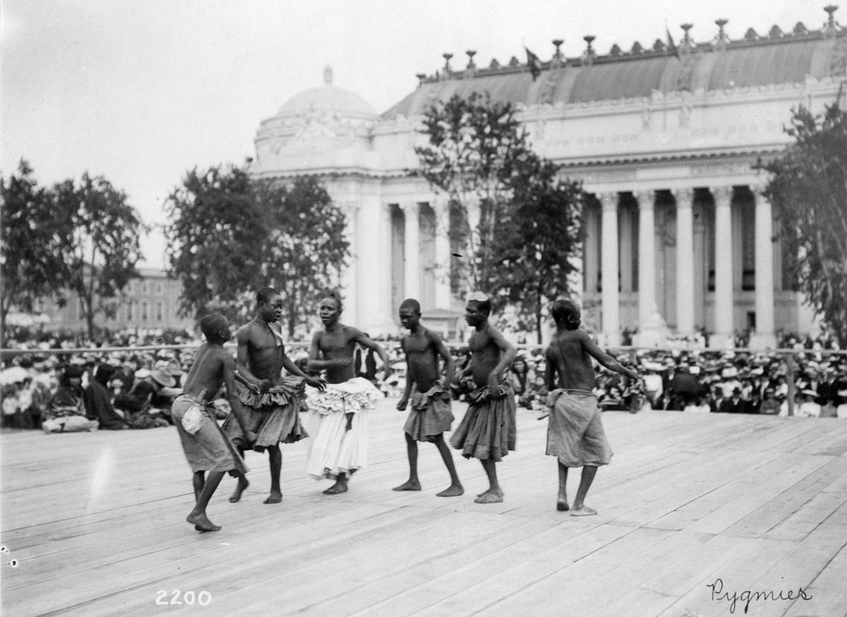 #71 Pygmies from Central Africa dancing on platform in front of the Palace of Manufactures at the 1904 World’s Fair on 28 July 1904