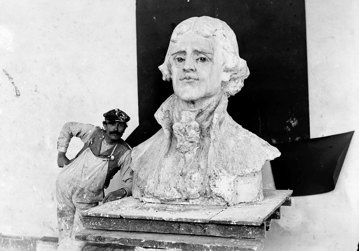 #21 A craftsman stands by a bust of Thomas Jefferson, the model for the statue by Charles Grafly installed at the Louisiana Purchase Exposition.