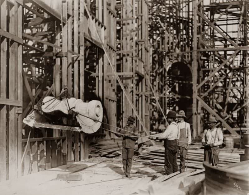#44 Workers hoisting the first piece of staff onto the Palace of Varied Industries for the 1904 World’s Fair, 1902