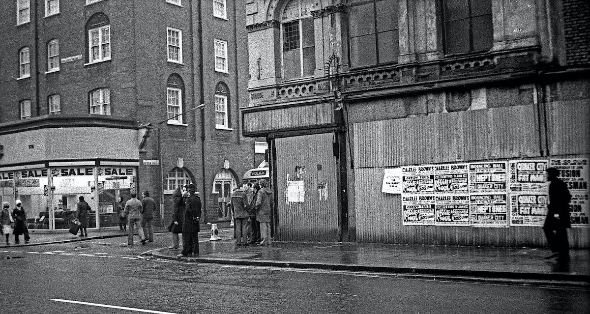 #24 Michael Ferreira’s funeral 1979 – a group of plainclothes policemen wait on the corner of Victorian Road.