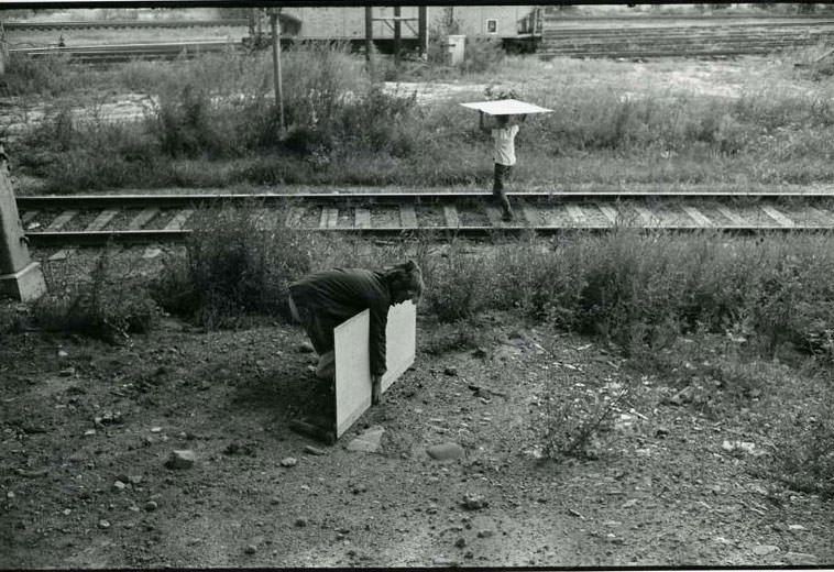 #12 Two children carrying boards over the railroad tracks by the Jefferson Park Housing Project, Jefferson Park, 1974