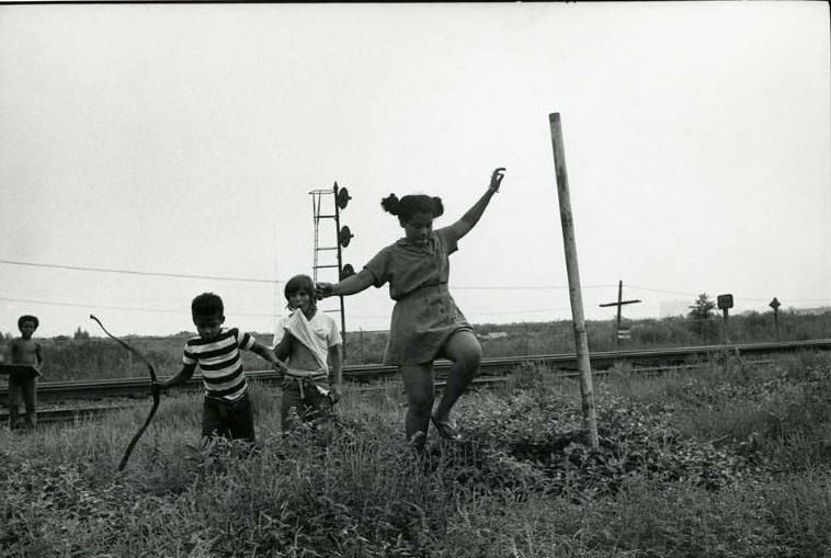 #6 Four children playing by the railroad tracks next to the Jefferson Park Housing Project, Jefferson Park, 1973