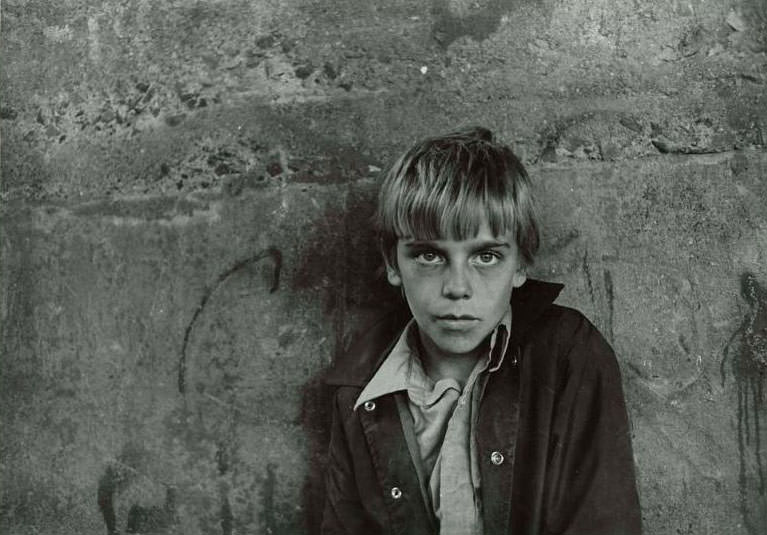 #10 Close up of a boy named Rico standing against a concrete background, Jefferson Park, 1974