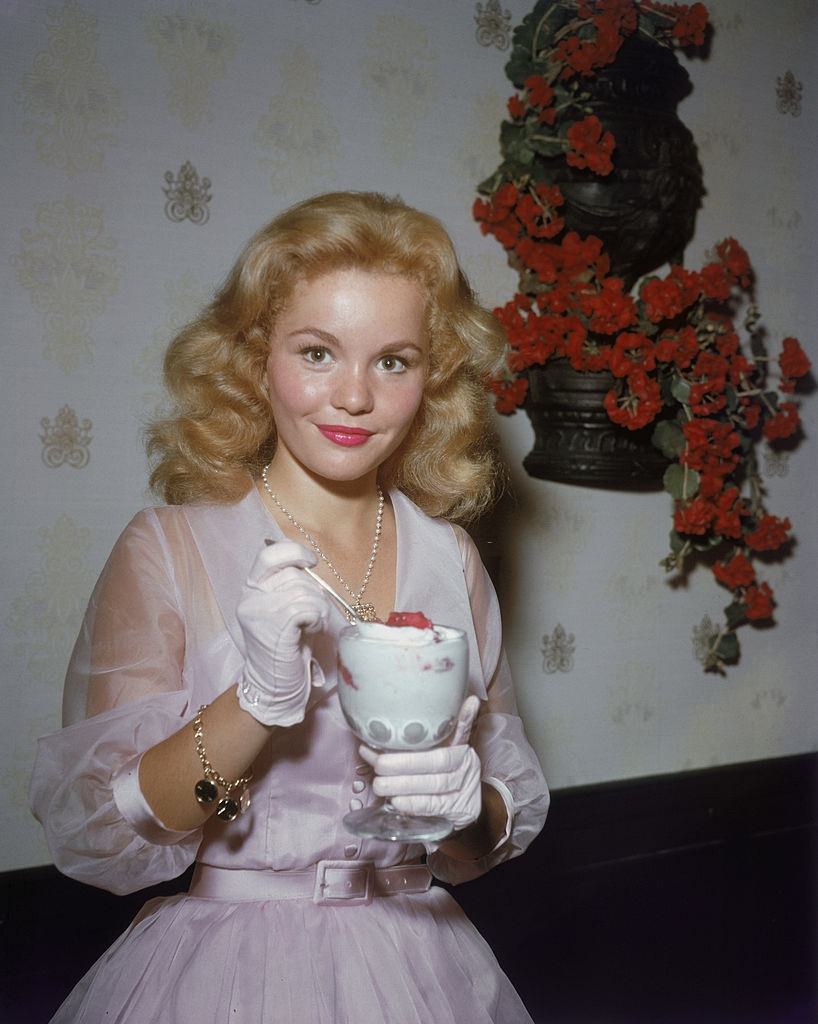 #64 Tuesday Weld enjoys an ice cream sundae, 1965.