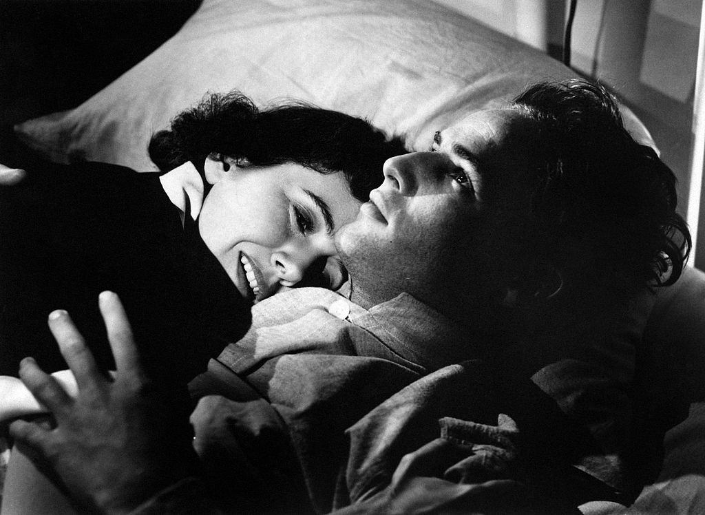 #4 Marlon Brando embracing American actress Teresa Wright on a bed, 1950.