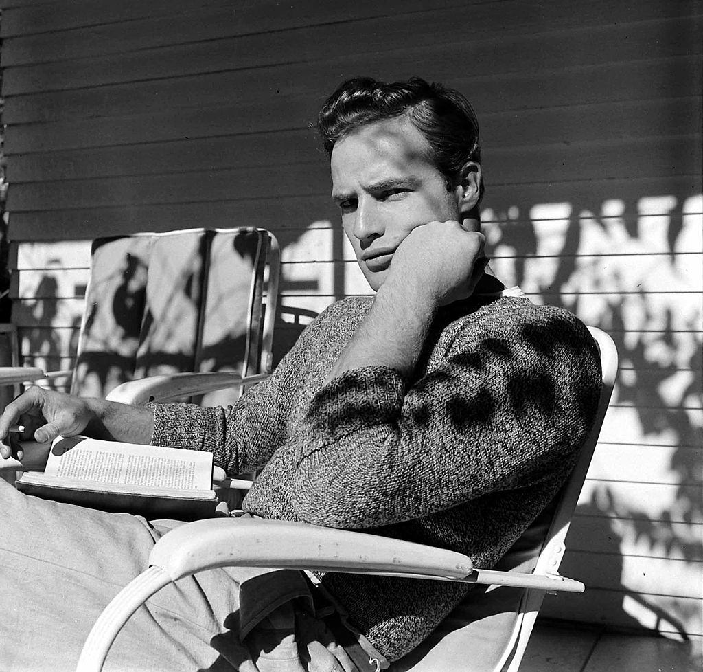 #31 Marlon Brando reads a book during a break in filming ‘The Men’, 1949.