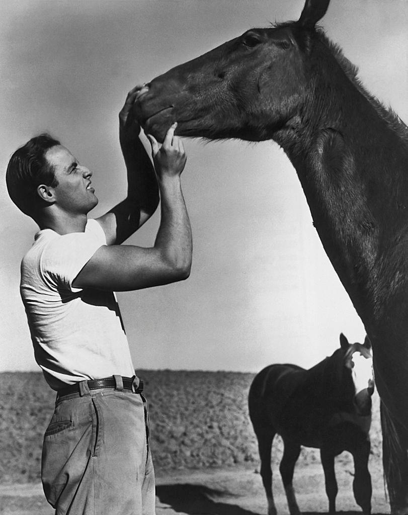 #35 Marlon Brando with a horse during the filming of ‘The Men’ in 1950.