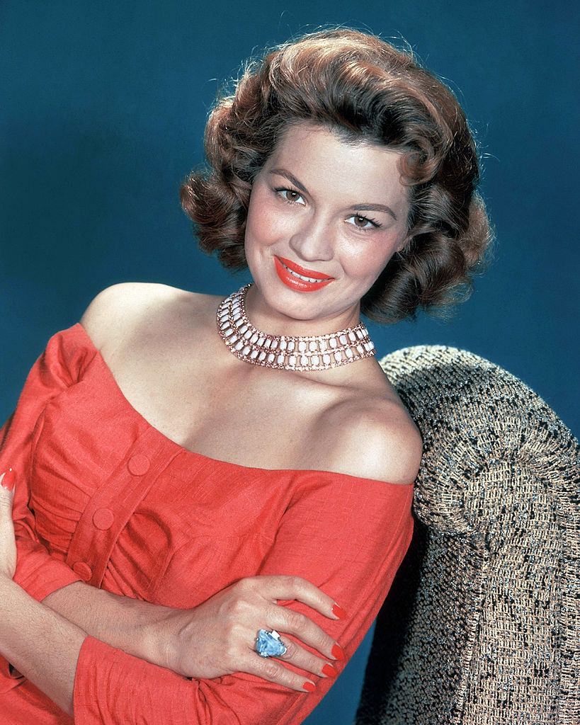 #38 Angie Dickinson in red dress and red lipstick, 1955.