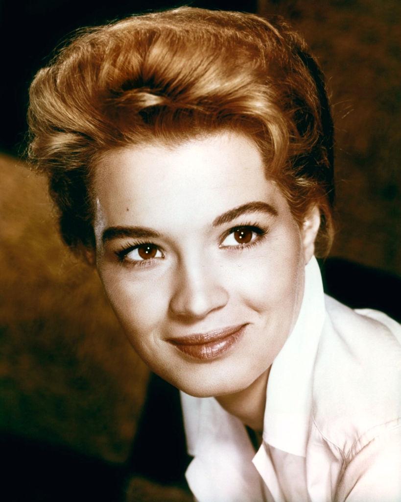 #27 Angie Dickinson wearing a white blouse in a studio portrait, 1960.