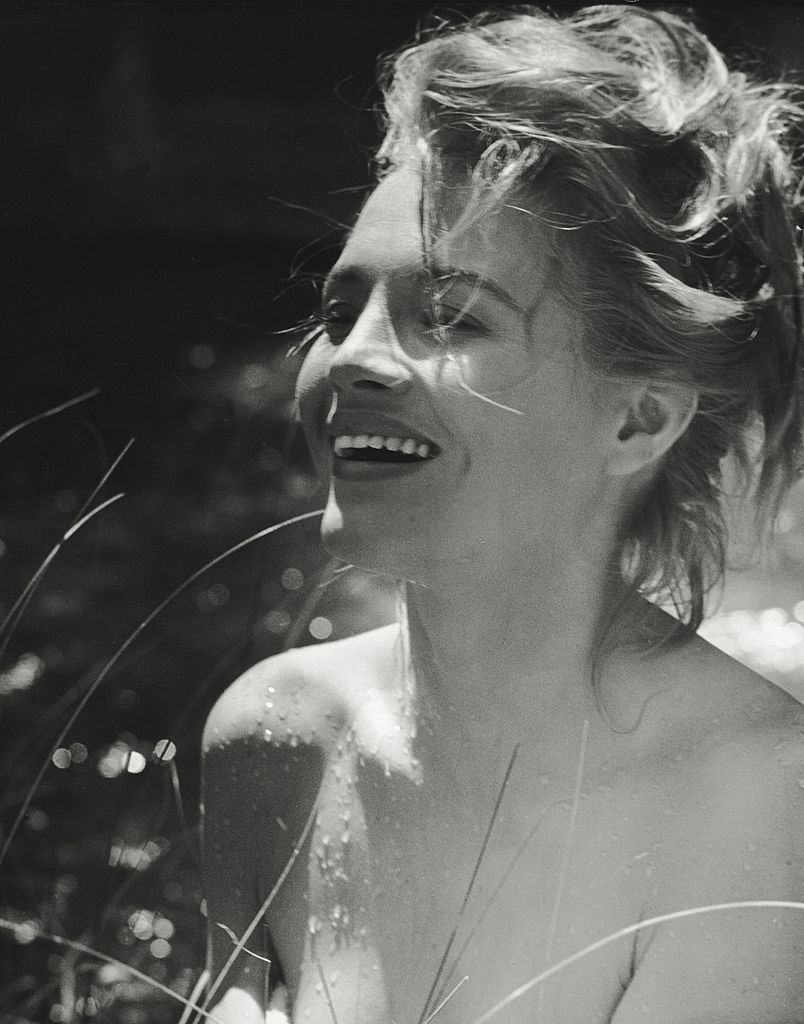#52 Angie Dickinson posing laughing after swimming. 1961