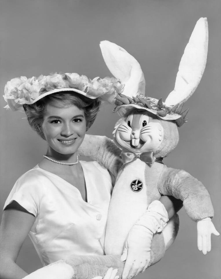 #71 Angie Dickinson takes a break from filming and strikes a pose with ‘Bugs Bunny’, 1961.