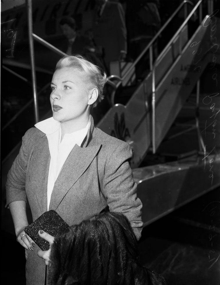 #15 Barbara Payton waiting at the airport, 1951.