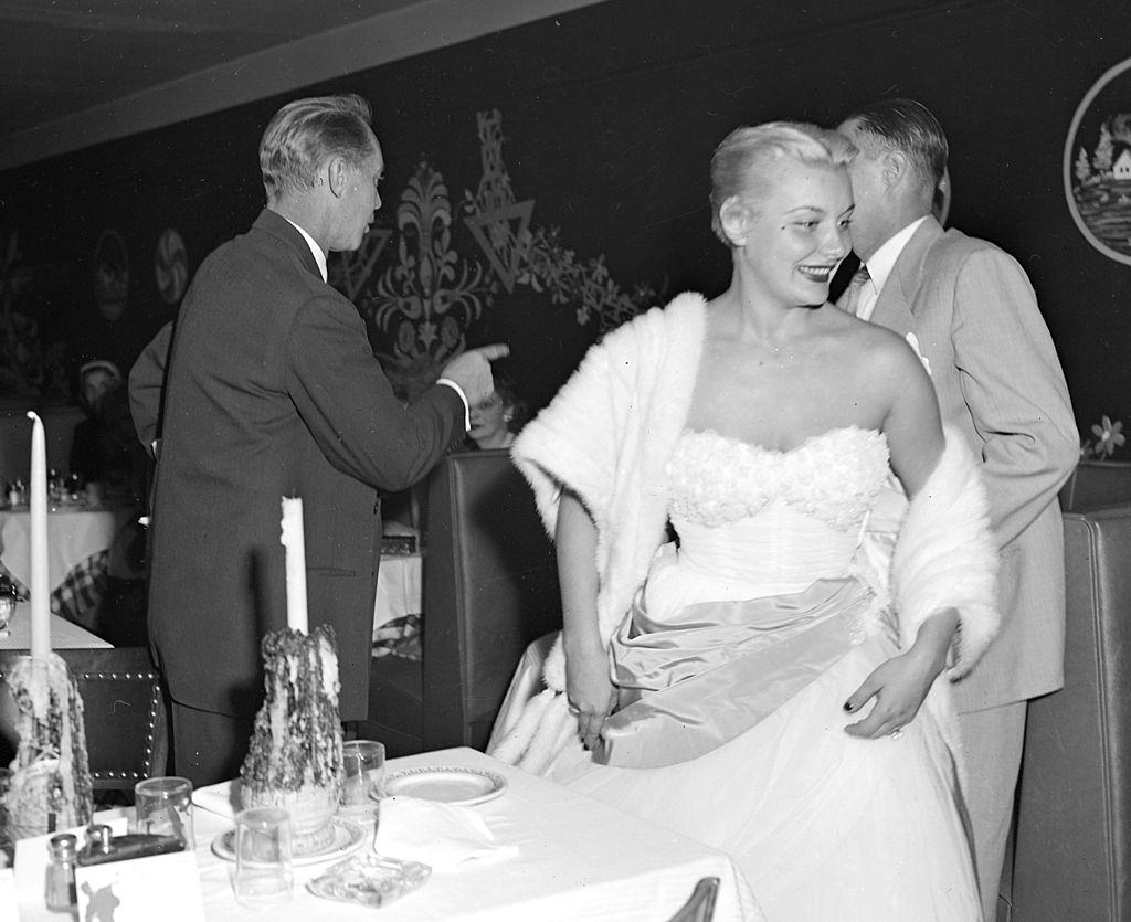 #32 Barbara Payton, leave table in Little Gypsy restaurant, 1951.