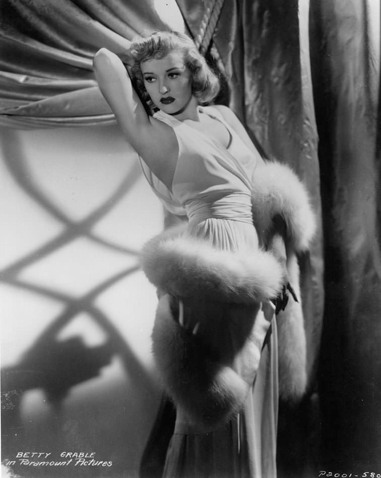 #8 Betty Grable in an evening gown and a white fur wrapped around her body, 1935.