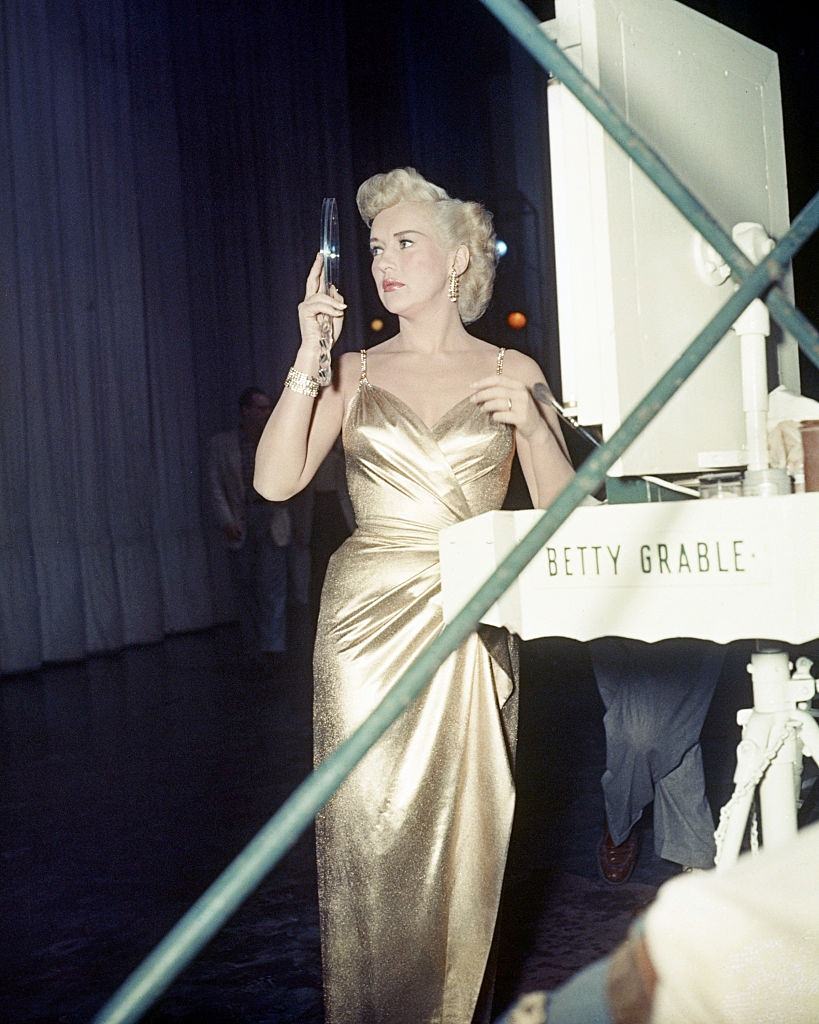 #51 Betty Grable in a gold dress, 1950.