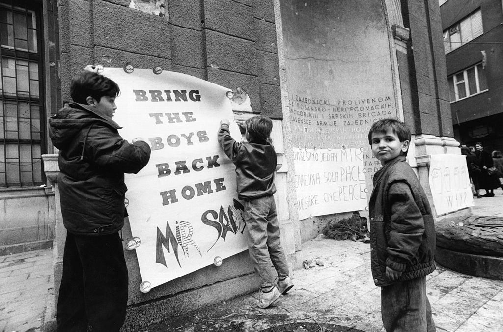 Boys putting up a poster saying ‘Bring the boys back home’ as part of a peace demonstration in Sarajevo, 1994.