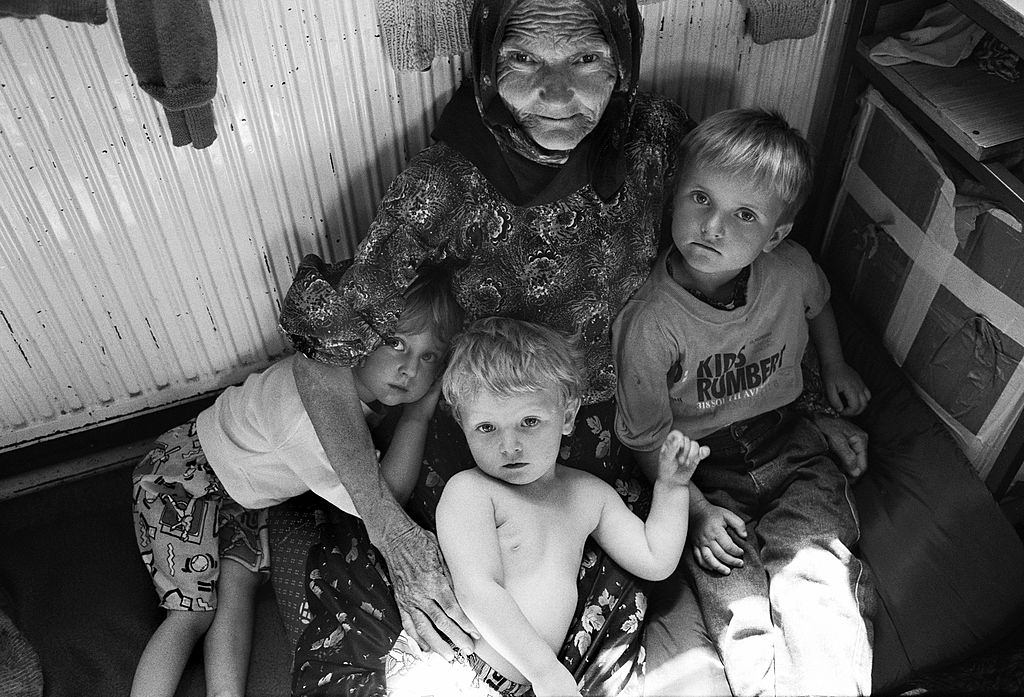 #9 A Muslim grandmother hugs her young grandchildren at a refugee centre set up near Tuzla for people fleeing the Srebrenica massacre.