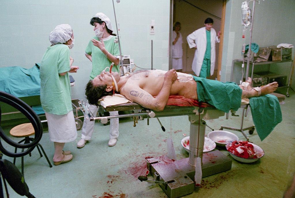 #12 A Bosnian fighter undergoes an emergency operation at a military hospital in Sarajevo after suffering an intestinal wound from a grenade attack.