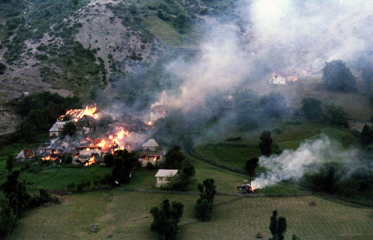 #18 Smoke and flames rise from houses set on fire by heavy fighting between Bosnian Serbs and Muslims in the village of Ljuta on Mount Igman some 40km southwest from the besieged Bosnian capital of Sarajevo, on July 22, 1993.