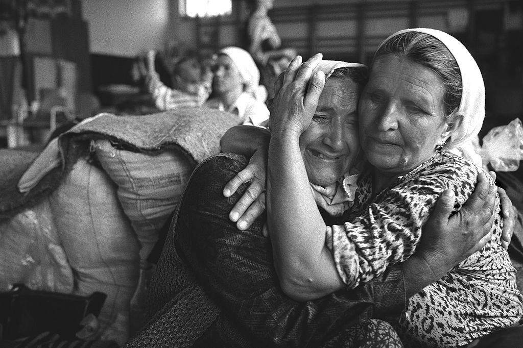 #4 Grieving elderly Muslim women pictured in a refugee centre set up to shelter Muslim families after they fled Srebrenica.