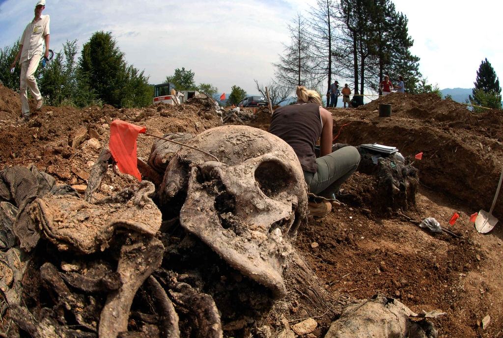 #5 Forensic experts work in a mass grave in the village of Budak, located some two-and-a-half kilometers from a memorial center for the massacre victims