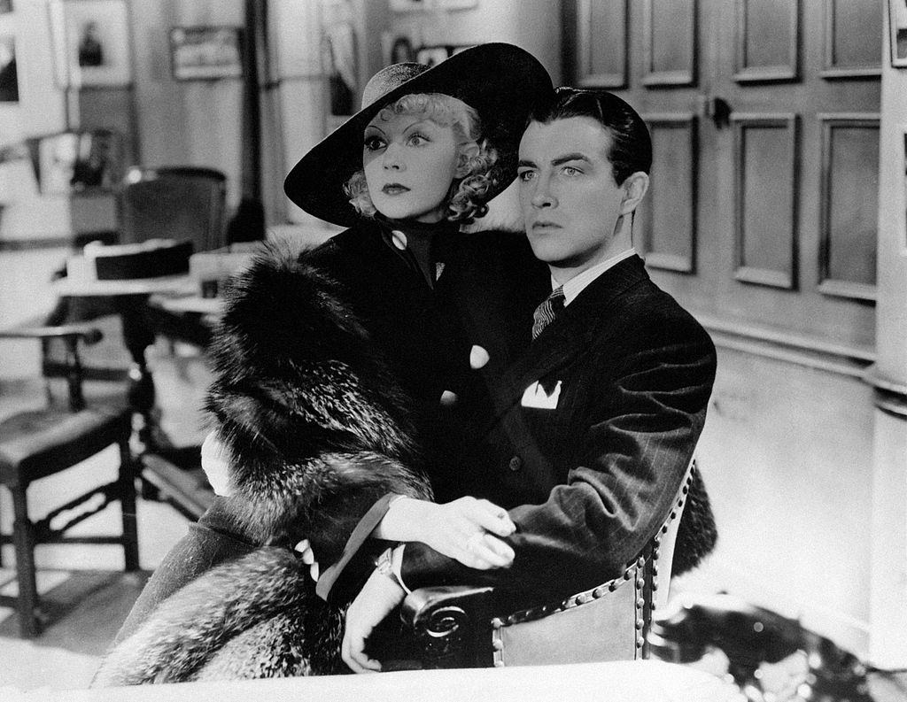 #22 Eleanor Powell, terrified, sits on Robert Taylor’s lap in the movie ‘Broadway Melody of 1938’.