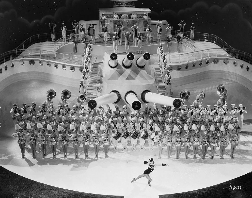 #25 Eleanor Powell performs to the tune of a brass band on the deck of a ship in the musical ‘Born To Dance’, 1936.