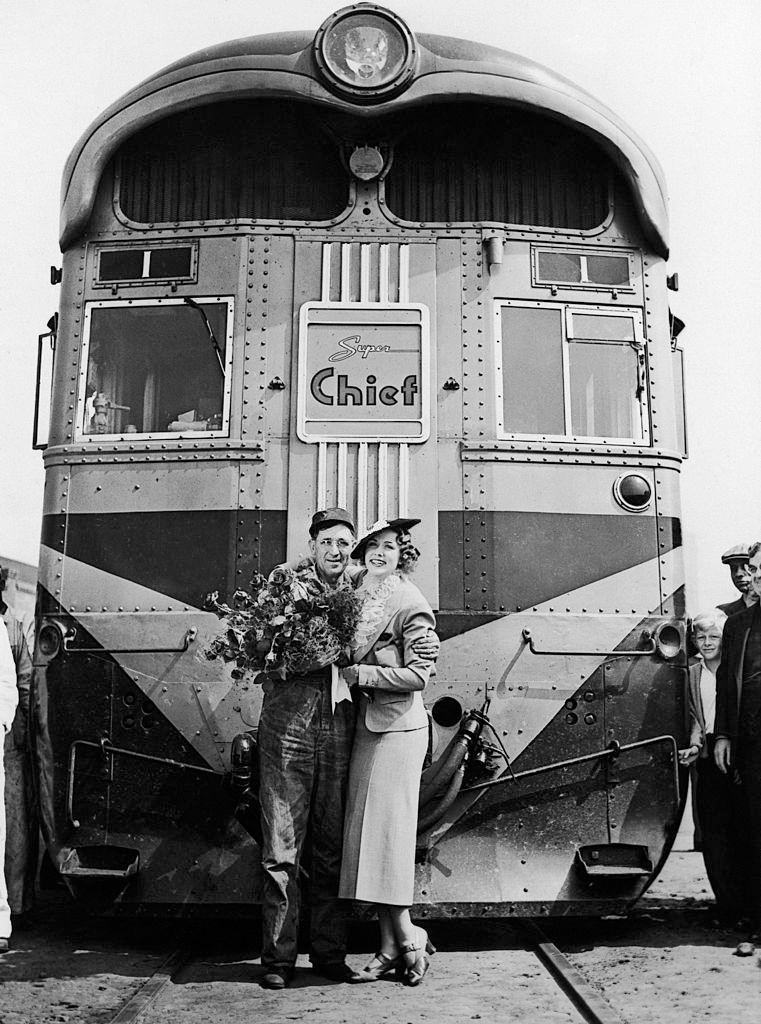 #7 Eleanor Powell arrives in Los Angeles, California aboard The Express Train Super Chief and posing with the Driver, 1936.