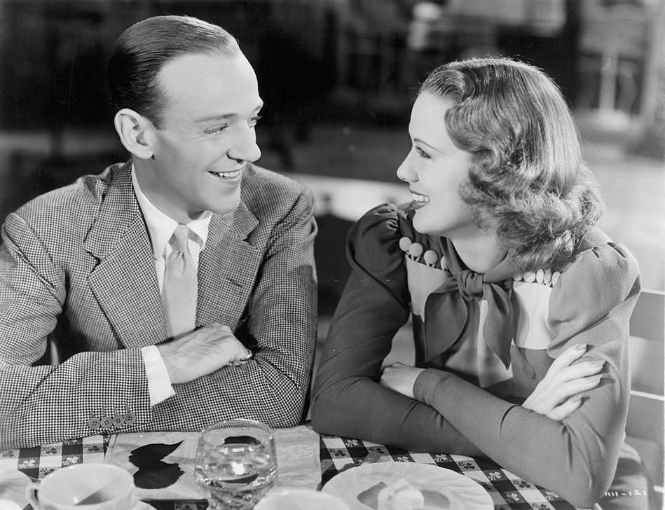 #15 Eleanor Powell and Fred Astair share a smile at the table in a scene from the film ‘Broadway Melody Of 1940’,