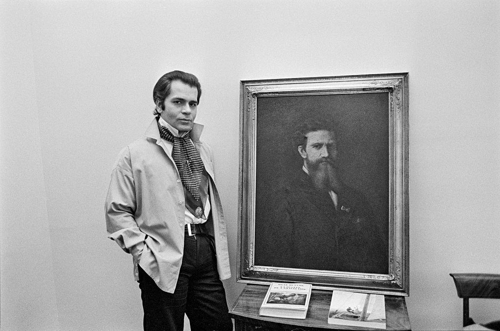 #15 Karl Lagerfeld posing with a painting, 1976.
