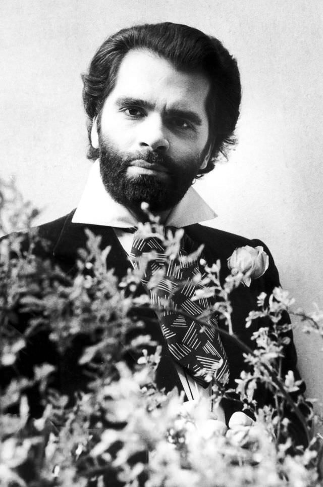 #5 Karl Lagerfeld posing behind flowers, 1950s.