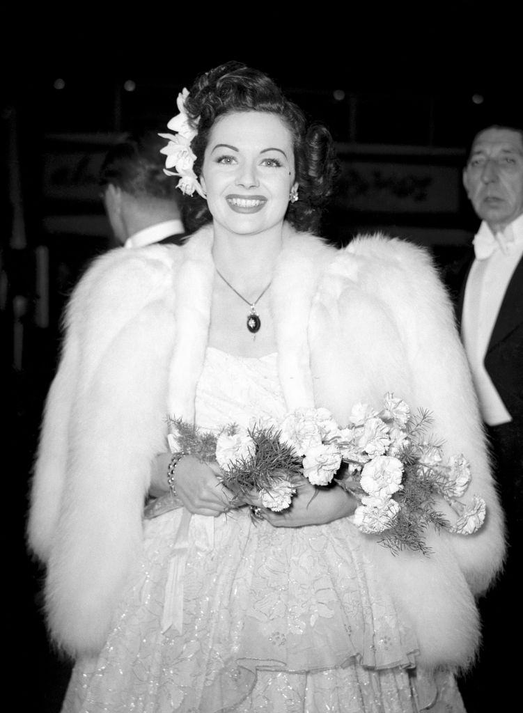 #46 Margaret Lockwood arrives for the premiere of White Unicorn, waring white furs, 1947.
