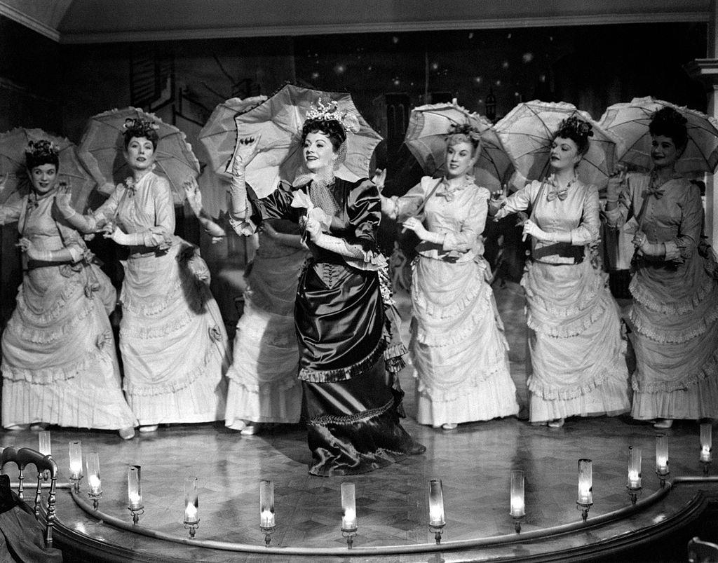 #53 Margaret Lockwood holding a parasol and singing in the film Laughing Anne, 1948.
