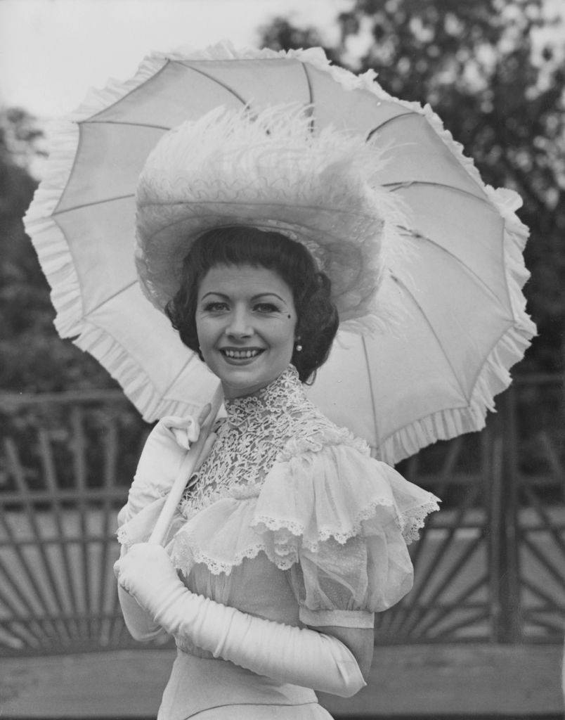 #71 Margaret Lockwood wearing period fashion to the Theatrical Garden Party at the Chelsea Royal Hospital, 1951.